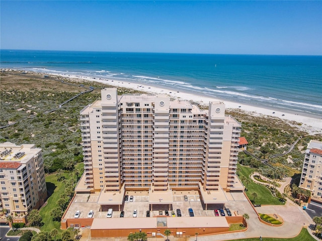 birds eye view of property featuring a beach view and a water view