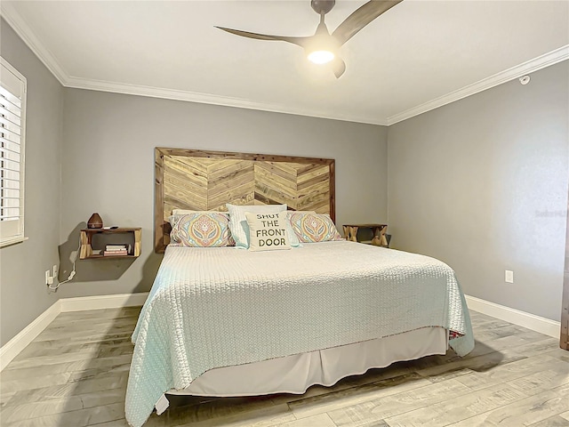 bedroom with ceiling fan, crown molding, and hardwood / wood-style flooring