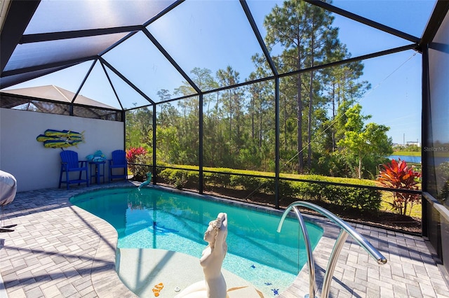 view of pool featuring a patio area and glass enclosure