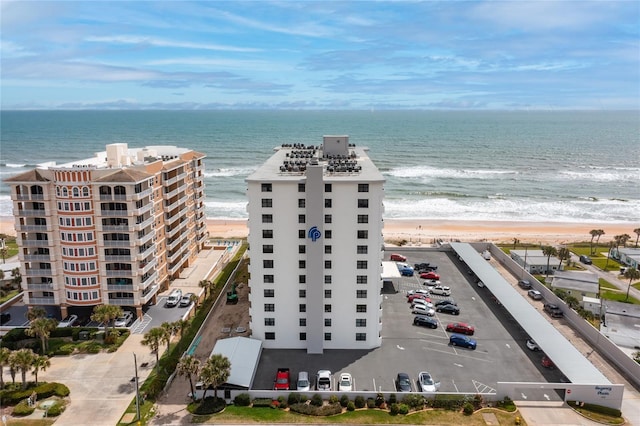 bird's eye view featuring a water view and a beach view