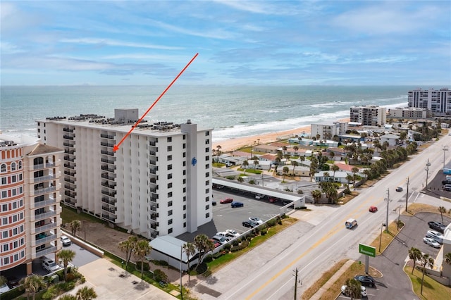 drone / aerial view with a water view and a view of the beach