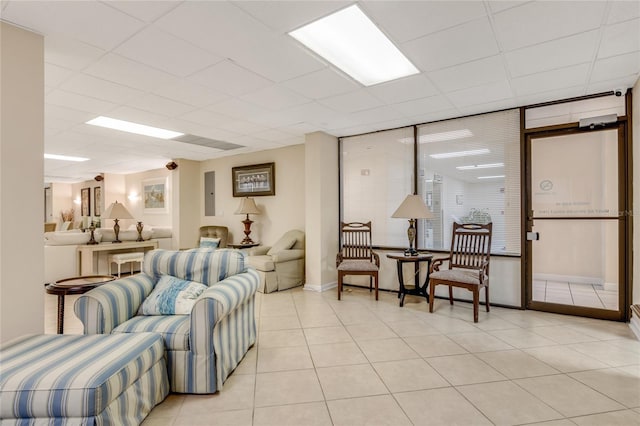 tiled living room with a paneled ceiling