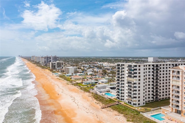 birds eye view of property with a water view and a view of the beach