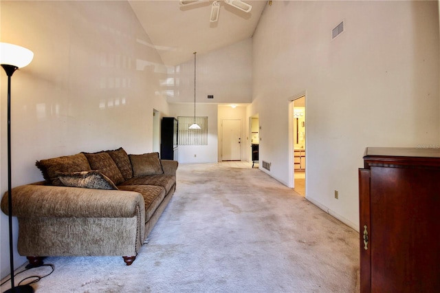 carpeted living room with high vaulted ceiling and ceiling fan