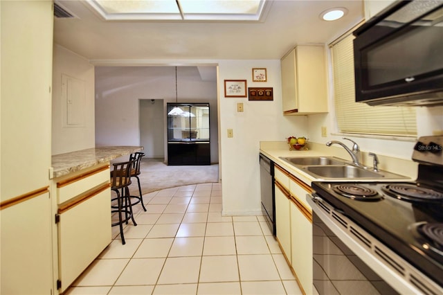 kitchen with sink, decorative light fixtures, light tile floors, and black appliances