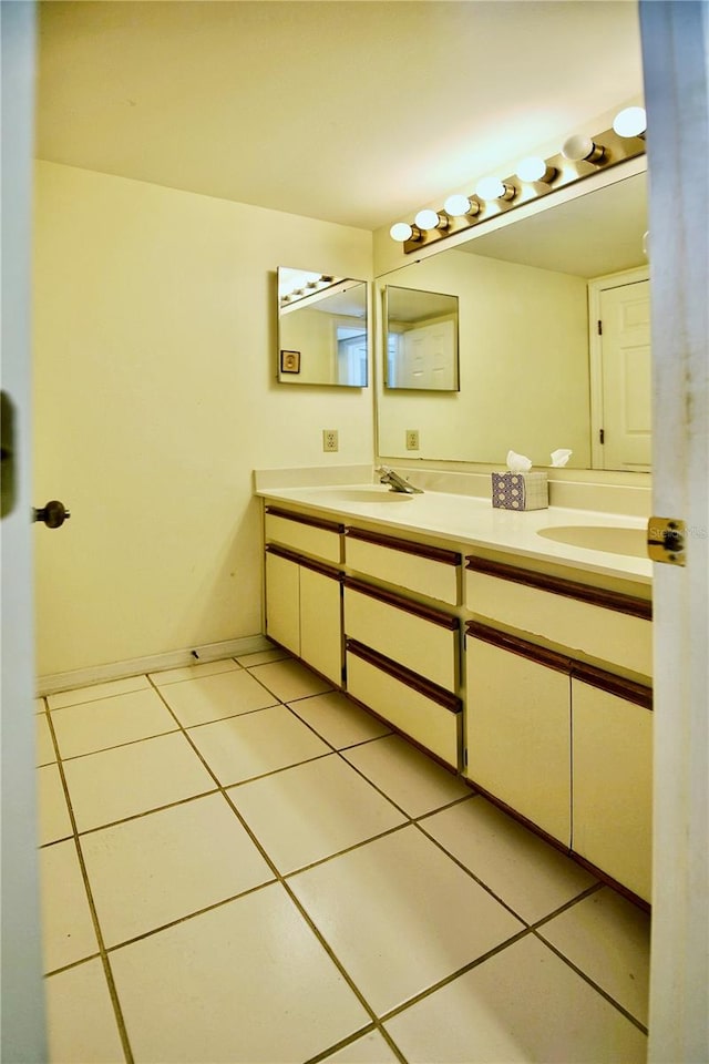 bathroom with tile flooring and double vanity