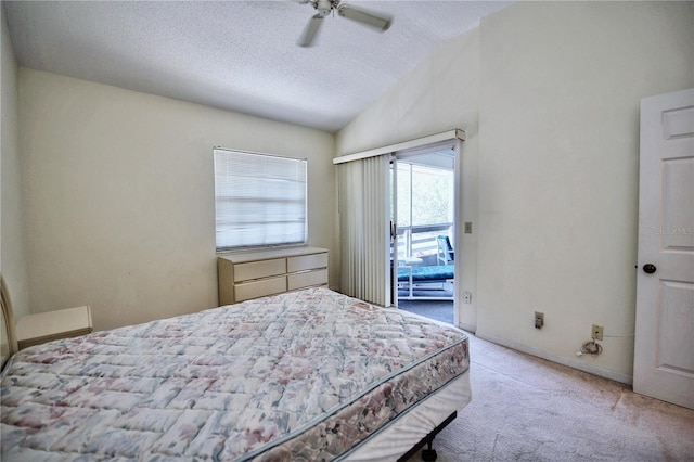 bedroom featuring carpet floors, vaulted ceiling, ceiling fan, and a textured ceiling