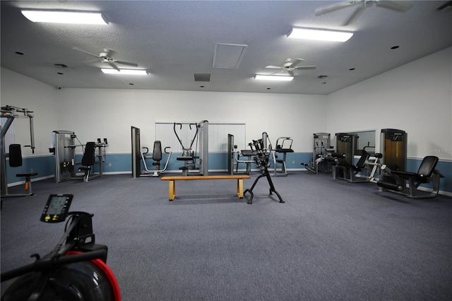 gym with baseboards, visible vents, a ceiling fan, and a textured ceiling