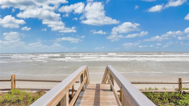 surrounding community featuring a view of the beach and a water view