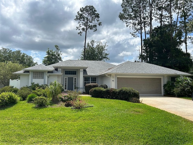 view of front of house with a front lawn and a garage