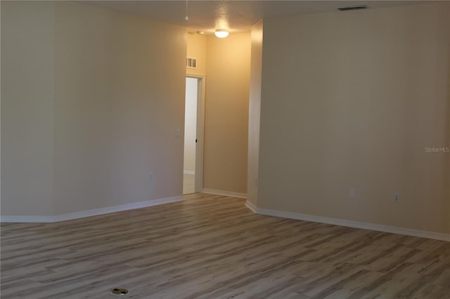 empty room with hardwood / wood-style flooring