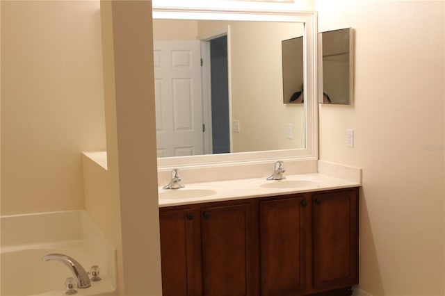 bathroom with vanity and a tub to relax in