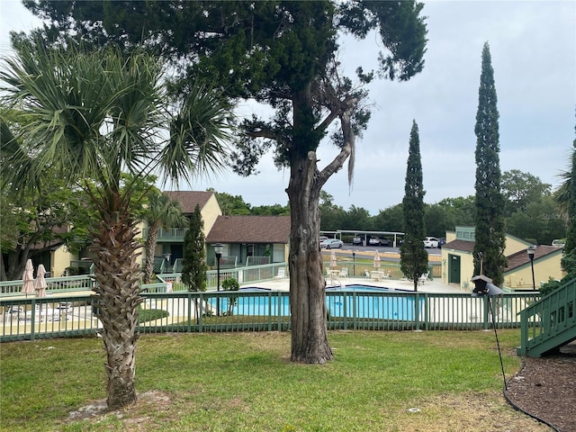 view of pool with a yard