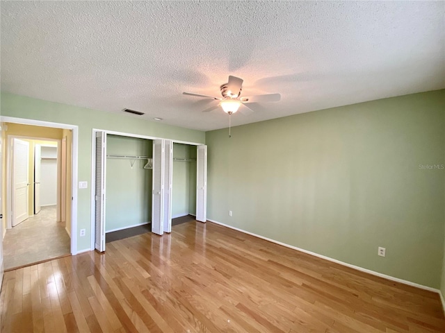 unfurnished bedroom featuring ceiling fan, light hardwood / wood-style flooring, and a textured ceiling