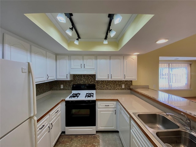 kitchen with sink, white appliances, rail lighting, and white cabinets