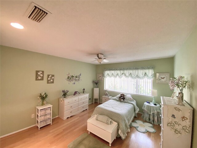 bedroom with light wood-type flooring and ceiling fan