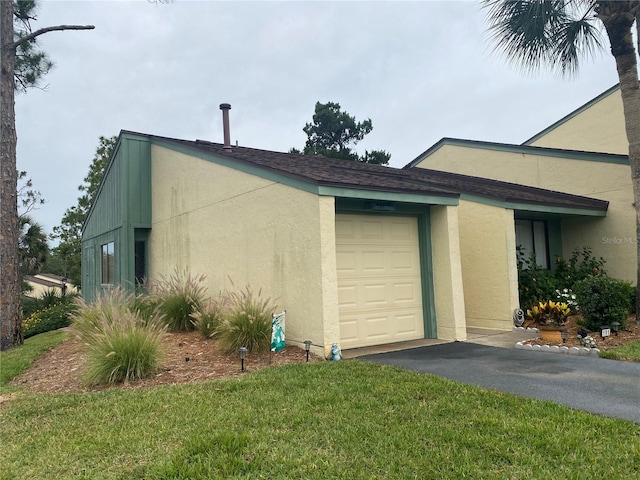 view of property exterior featuring a garage and a yard