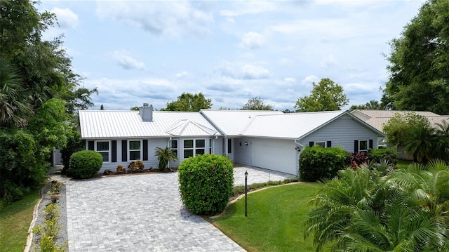 single story home with a front lawn and a garage