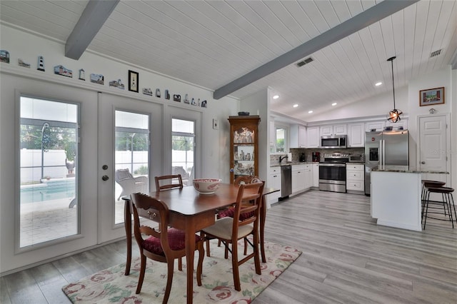 dining room featuring sink, french doors, vaulted ceiling with beams, and light wood-type flooring