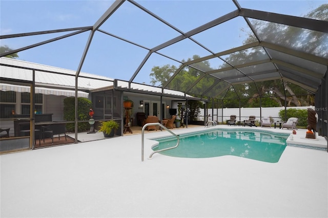 view of swimming pool with a patio area and a lanai