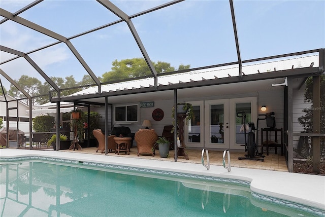 rear view of house featuring french doors, a patio area, and a lanai