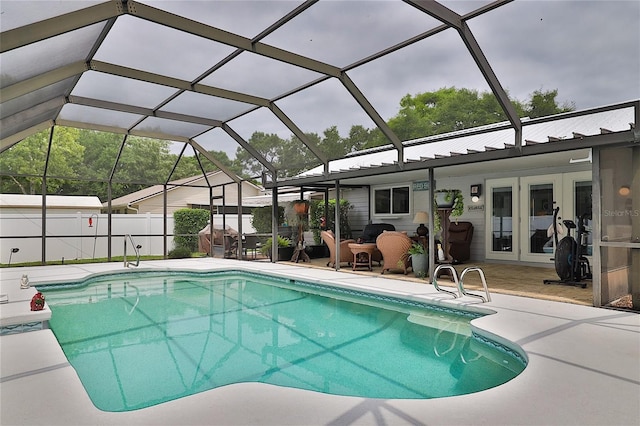 view of swimming pool featuring a patio, french doors, and a lanai