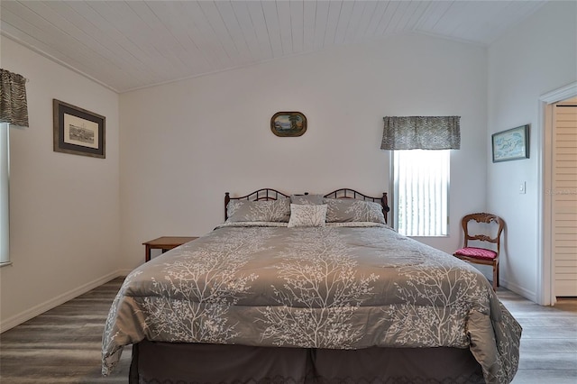 bedroom featuring vaulted ceiling, wood ceiling, and wood-type flooring