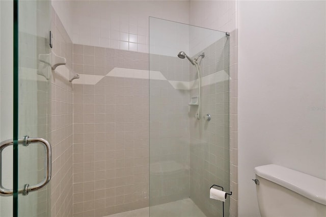 bathroom with toilet and walk in shower