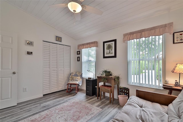 living area with ceiling fan, hardwood / wood-style flooring, wooden ceiling, and lofted ceiling