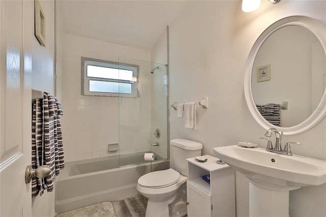 full bathroom with toilet, tiled shower / bath combo, and sink