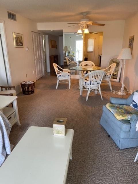 carpeted living room with ceiling fan