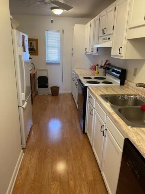 kitchen with light hardwood / wood-style floors, white cabinetry, white appliances, sink, and ceiling fan