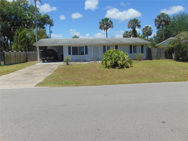 ranch-style home with a carport and a front yard