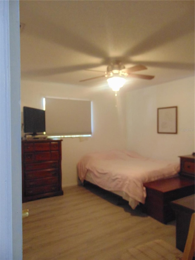 bedroom with ceiling fan and hardwood / wood-style floors