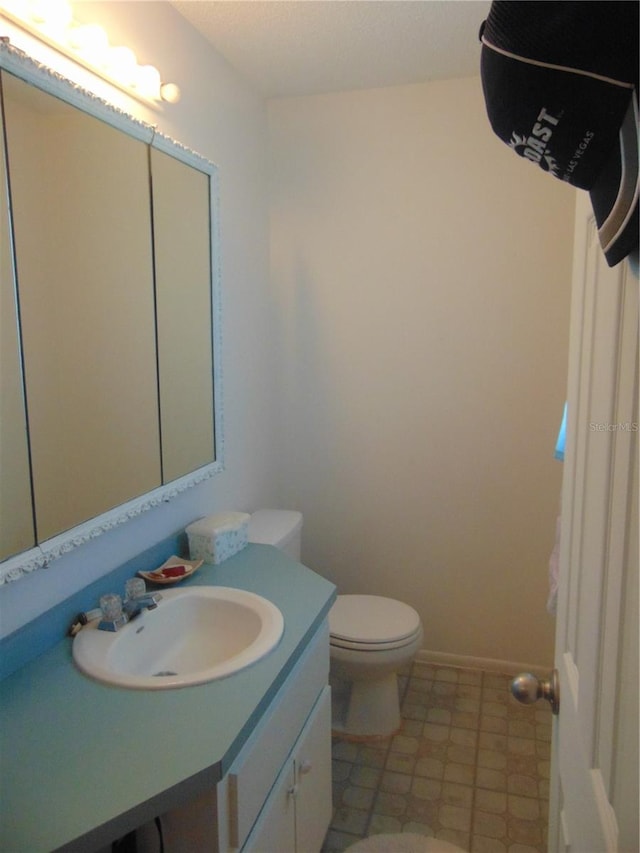 bathroom featuring tile flooring, oversized vanity, and toilet