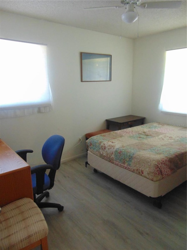 bedroom with ceiling fan and hardwood / wood-style floors