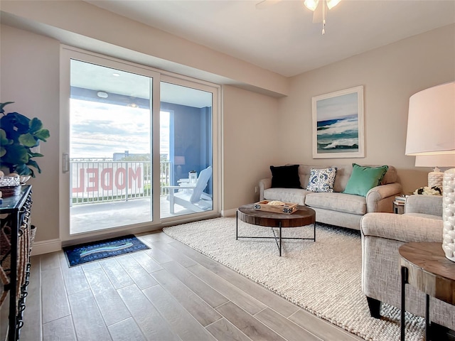 living room with wood-type flooring and ceiling fan