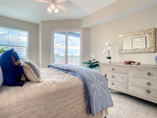 bedroom featuring ceiling fan, multiple windows, carpet floors, and access to exterior