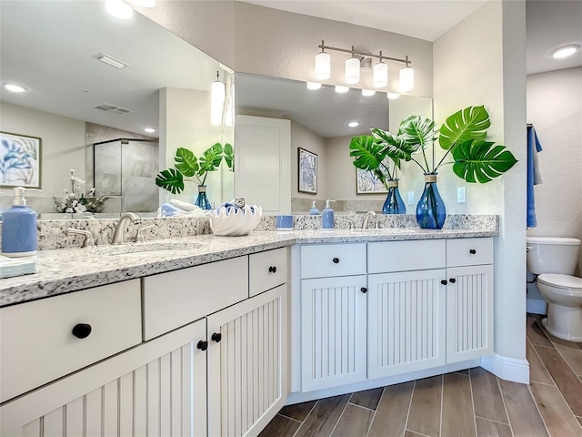 bathroom featuring double vanity and toilet