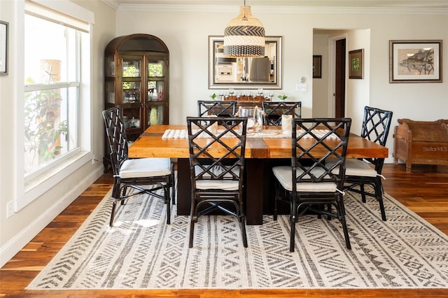 4606 Doris Dr, New Smyrna Beach, FL 32169 - dining space with dark wood-type flooring, crown molding, and healthy amount of natural light