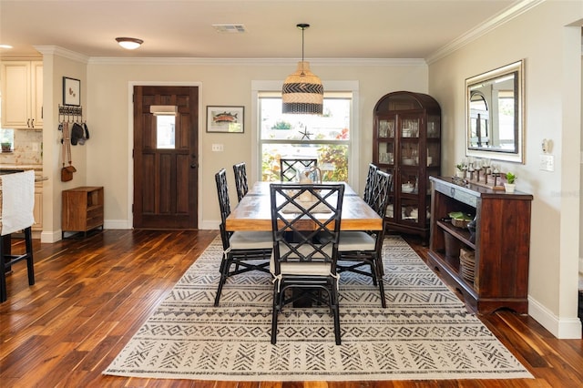 4606 Doris Dr, New Smyrna Beach, FL 32169 - dining room featuring dark wood-type flooring, healthy amount of natural light, and crown molding