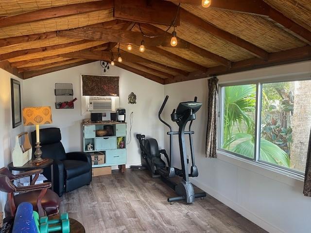4606 Doris Dr, New Smyrna Beach, FL 32169 - workout room featuring wood finished floors, vaulted ceiling, and cooling unit