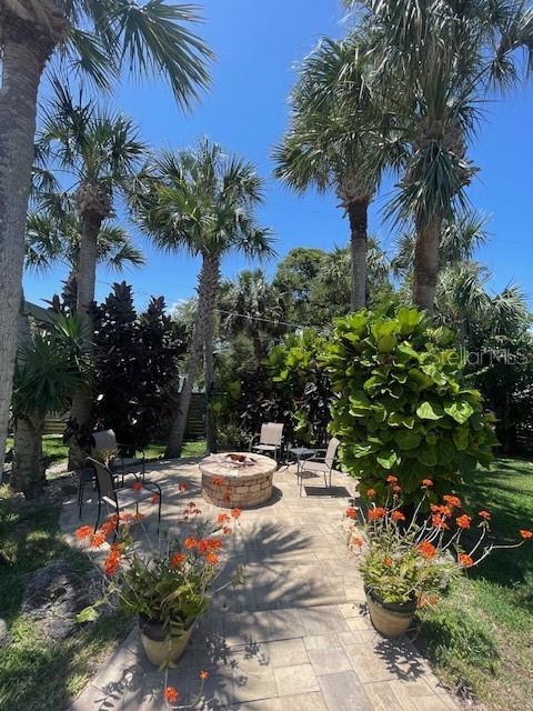 4606 Doris Dr, New Smyrna Beach, FL 32169 - view of home's community featuring an outdoor fire pit and a patio
