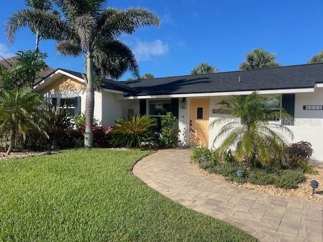 4606 Doris Dr, New Smyrna Beach, FL 32169 - ranch-style home featuring a front lawn and stucco siding