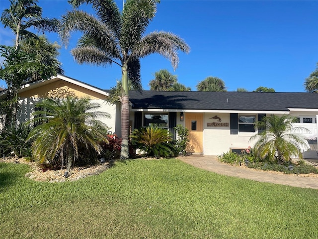 4606 Doris Dr, New Smyrna Beach, FL 32169 - single story home featuring a front lawn, stucco siding, and roof with shingles