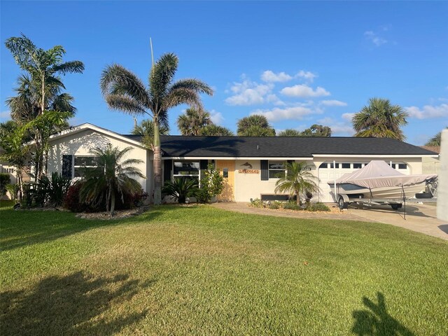 4606 Doris Dr, New Smyrna Beach, FL 32169 - view of front facade with an attached garage, a front yard, and concrete driveway