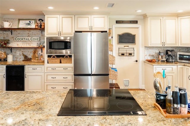 4606 Doris Dr, New Smyrna Beach, FL 32169 - kitchen with stainless steel appliances, wine cooler, cream cabinetry, crown molding, and tasteful backsplash