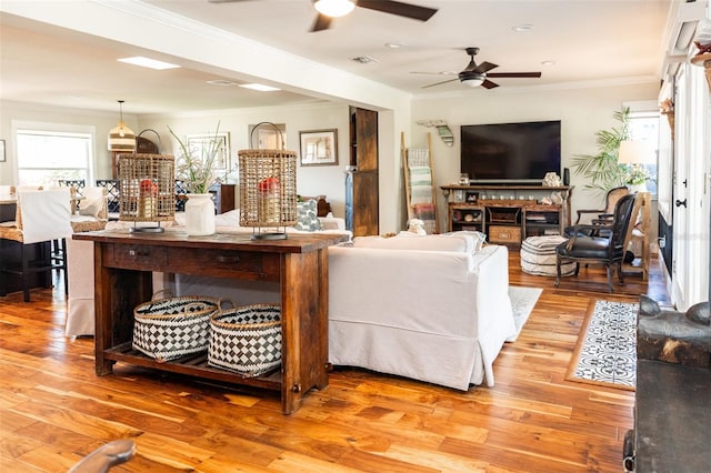 4606 Doris Dr, New Smyrna Beach, FL 32169 - living room featuring a ceiling fan, ornamental molding, light wood finished floors, and a fireplace