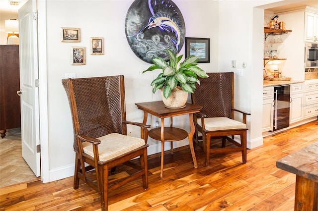 4606 Doris Dr, New Smyrna Beach, FL 32169 - living area featuring wine cooler, bar, and light wood-style floors