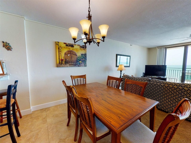 dining space with light tile floors, a notable chandelier, a textured ceiling, and a water view